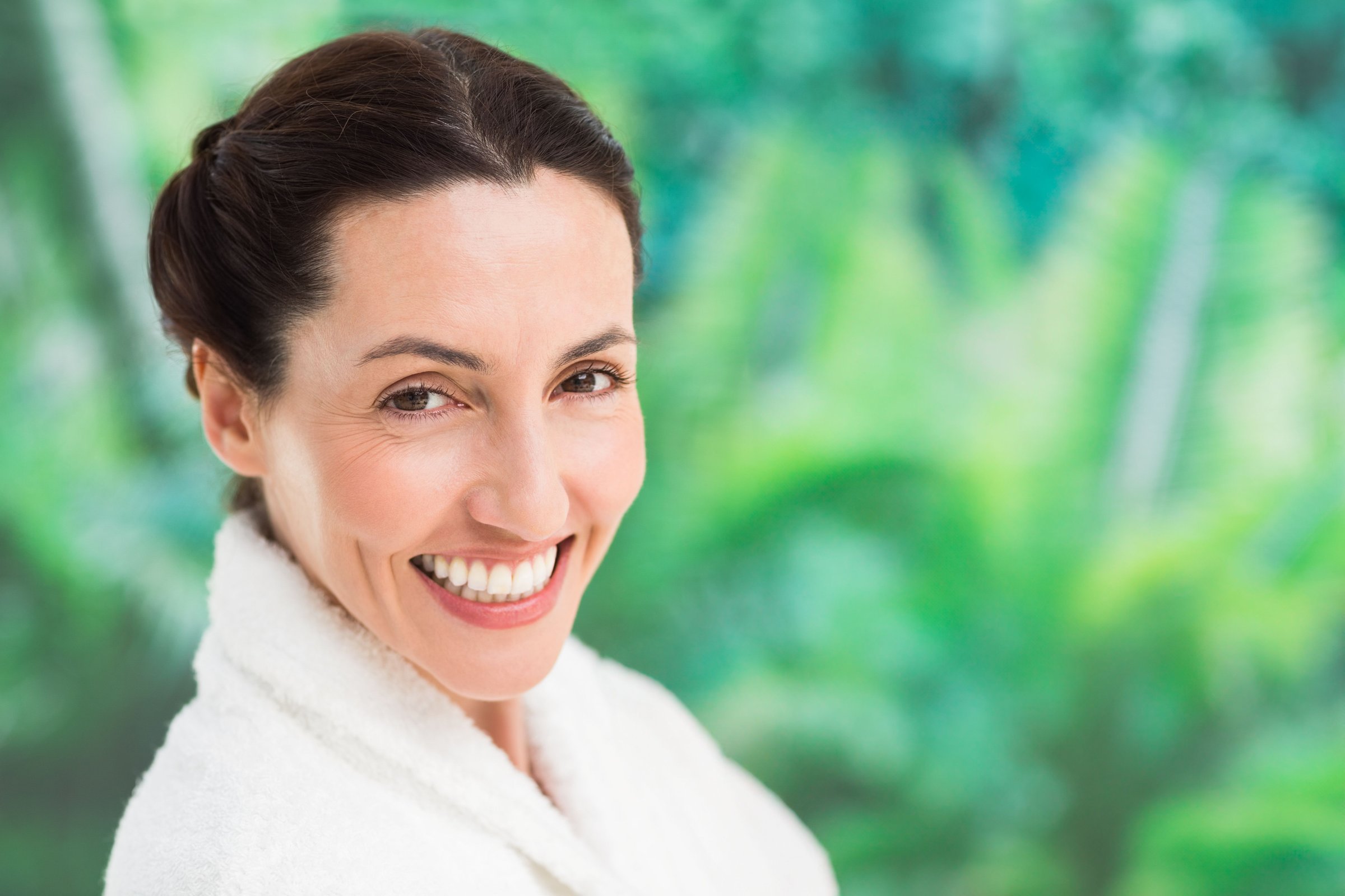 A woman in her forties smiling at a wellness retreat